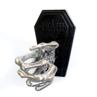 Skeleton hand on a coffin shaped plate to be mounted on a wall to hold a tattoo machine. Currently holding a Fk irons Flux tattoo machine