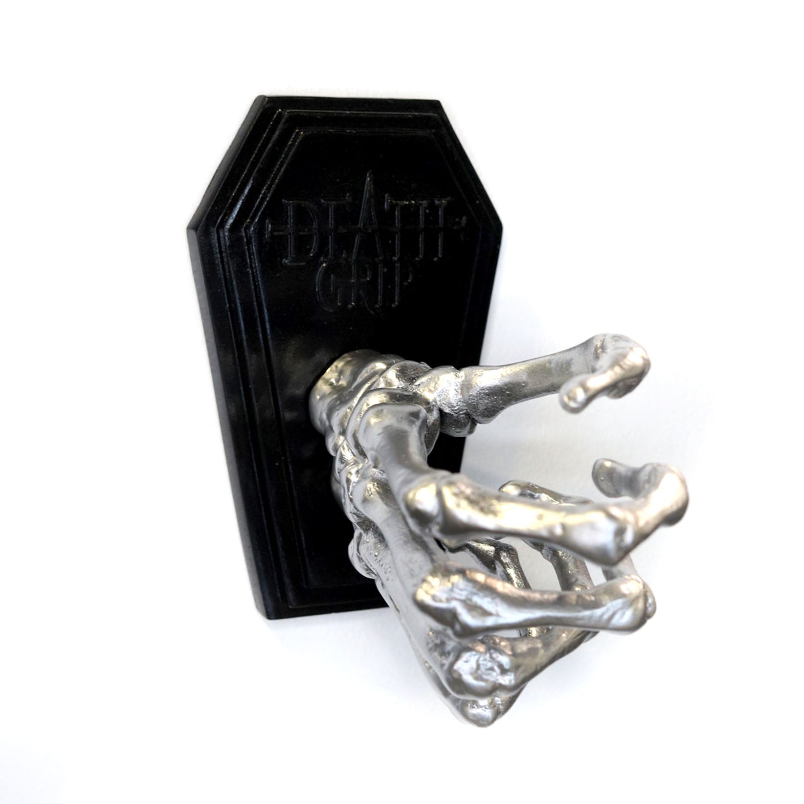 Skeleton hand on a coffin shaped plate to be mounted on a wall to hold a tattoo machine. 